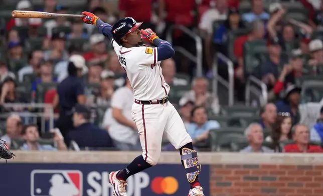 Atlanta Braves second baseman Ozzie Albies hits a double during the sixth inning in Game 4 of baseball's National League Division Series against the Los Angeles Dodgers, Wednesday, Oct. 7, 2026, in Atlanta. (AP Photo/Mike Stewart)
