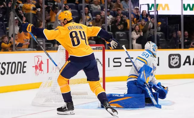 Nashville Predators center Adam Edstrom (84) celebrates his goal against St. Louis Blues goaltender Jordan Binnington (50) during the second period of an NHL hockey game Saturday, Oct. 17, 2026, in Nashville, Tenn. (AP Photo/George Walker IV)
