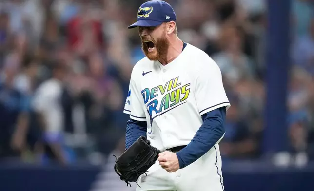 Tampa Bay Rays pitcher Cam Booser celebrates the third out in the against the Cleveland Guardians during the sixth inning in Game 6 of an American League Championship Series baseball game in St. Petersburg, Fla. Monday, Oct. 19, 2026. (AP Photo/David J. Phillip)