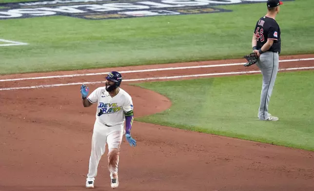 Tampa Bay Rays' Junior Caminero celebrates a two-run home run against the Cleveland Guardians during the seventh inning in Game 6 of an American League Championship Series baseball game in St. Petersburg, Fla. Monday, Oct. 19, 2026. (AP Photo/Chris O'Meara)