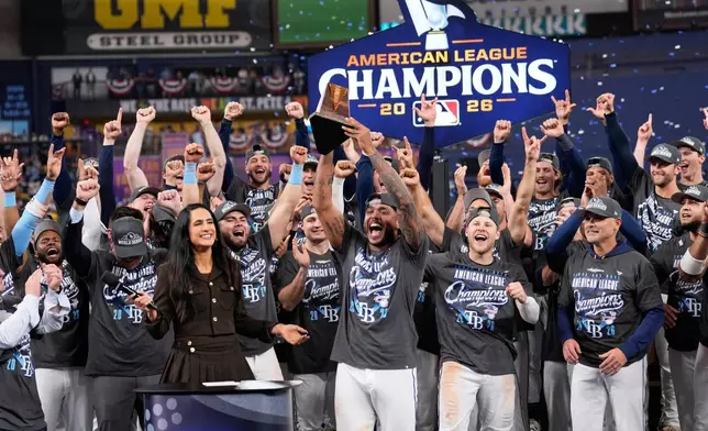 Tampa Bay Rays pitcher Freddy Peralta hold the MVP trophy after their win against the Cleveland Guardians in Game 6 of an American League Championship Series baseball game in St. Petersburg, Fla. Monday, Oct. 19, 2026. (AP Photo/David J. Phillip)