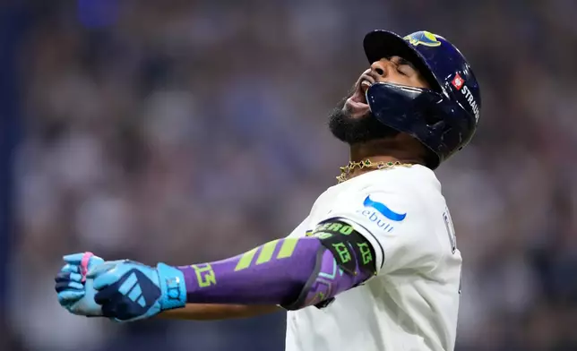 Tampa Bay Rays' Junior Caminero celebrates a two-run home run against the Cleveland Guardians during the seventh inning in Game 6 of an American League Championship Series baseball game in St. Petersburg, Fla. Monday, Oct. 19, 2026. (AP Photo/David J. Phillip)