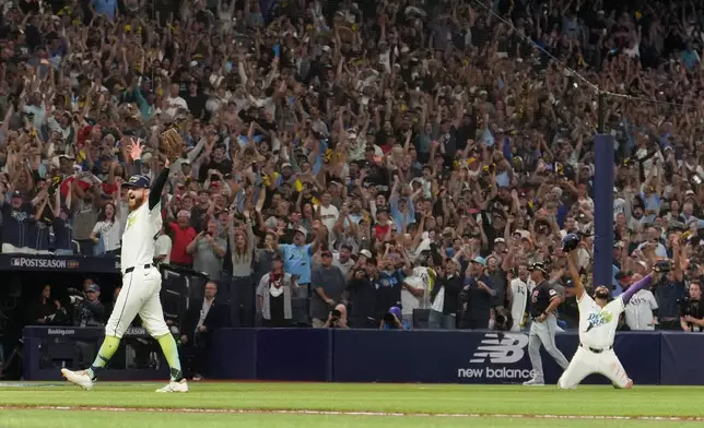 Tampa Bay Rays pitcher Bryan Baker celebrates their win against the Cleveland Guardians in Game 6 of an American League Championship Series baseball game in St. Petersburg, Fla. Monday, Oct. 19, 2026. (AP Photo/David J. Phillip)