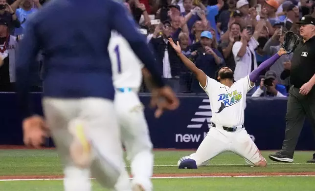 Tampa Bay Rays third baseman Junior Caminero celebrates their win against the Cleveland Guardians in Game 6 of an American League Championship Series baseball game in St. Petersburg, Fla. Monday, Oct. 19, 2026. (AP Photo/David J. Phillip)