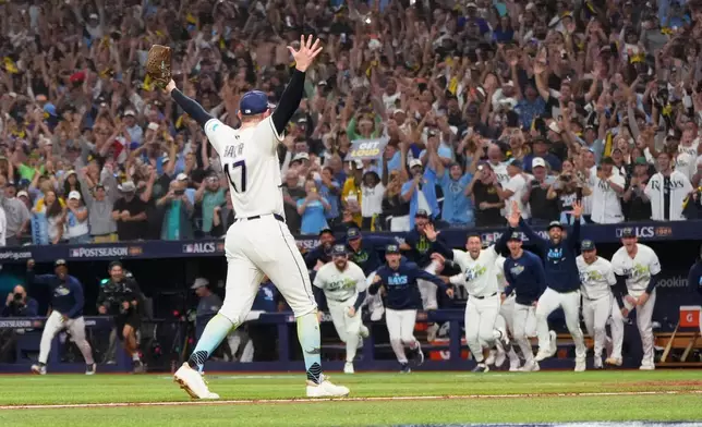 Tampa Bay Rays pitcher Bryan Baker celebrates their win against the Cleveland Guardians in Game 6 of an American League Championship Series baseball game in St. Petersburg, Fla. Monday, Oct. 19, 2026. (AP Photo/David J. Phillip)