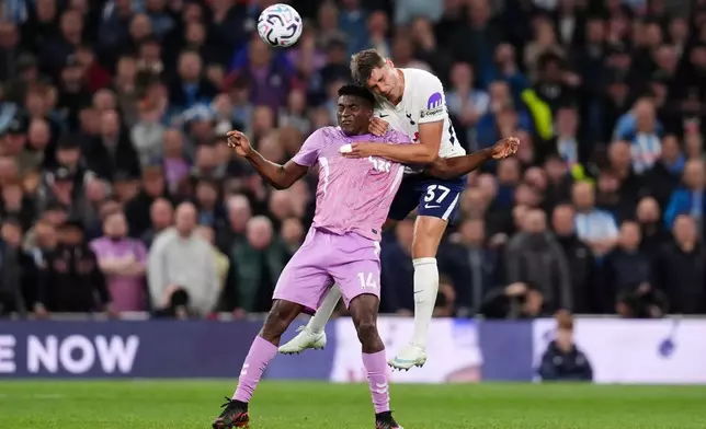 Coventry City's Taiwo Awoniyi, left, and Tottenham Hotspur's Micky van de Ven in action during the English Premier League soccer match between Tottenham Hotspur and Coventry City in London, Monday Oct. 19, 2026. (John Walton/PA via AP)