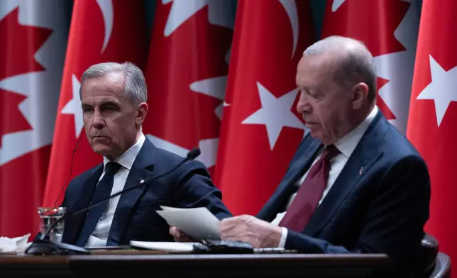 Prime Minister Mark Carney, left, looks on as Turkish President Recep Tayyip Erdogan reads his statement in Ankara, Turkey on Thursday, Oct. 22, 2026. (Adrian Wyld /The Canadian Press via AP)