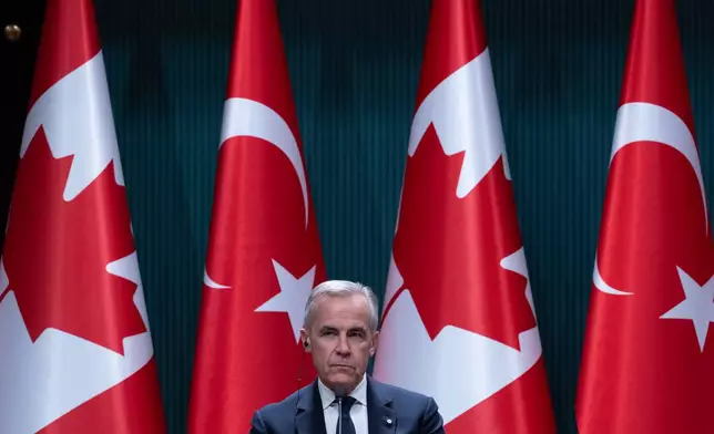 Prime Minister Mark Carney sits on stage and listens during a joint news conference with Turkish President Recep Tayyip Erdogan in Ankara, Turkey on Thursday, Oct. 22, 2026. (Adrian Wyld /The Canadian Press via AP)