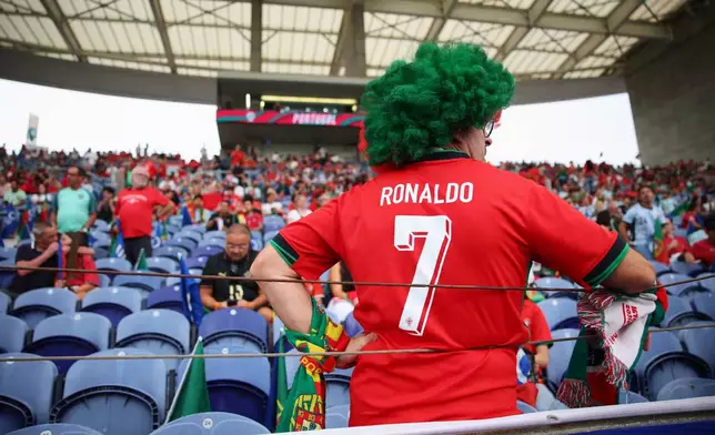A fan wearing Portugal's Cristiano Ronaldo shirt on the stands waits for the start of the Nations League soccer match between Portugal and Norway in Porto, Portugal, Sunday, Oct. 4, 2026. (AP Photo/Luis Vieira)