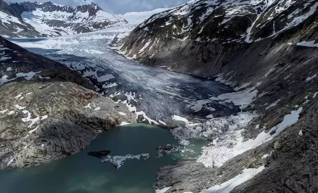 FILE — A lake of meltwater has formed on the tongue of the Rhone glacier near Goms, Switzerland, June 13, 2023. (AP Photo/Matthias Schrader, File)