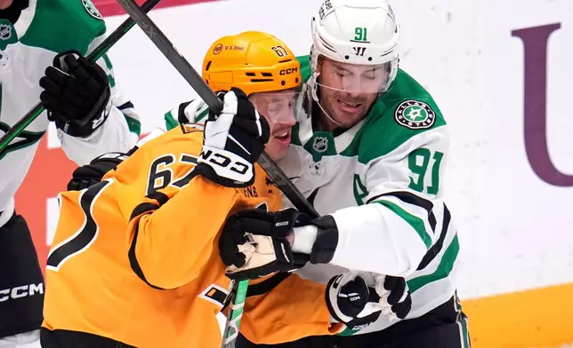 Dallas Stars' Tyler Seguin (91) defends against Pittsburgh Penguins' Rickard Rakell (67) during the first period of an NHL hockey game in Pittsburgh, Saturday, Oct. 10, 2026. (AP Photo/Gene J. Puskar)