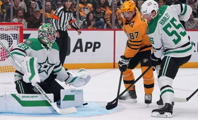 Pittsburgh Penguins' Sidney Crosby (87) cannot shoot past Dallas Stars goaltender Jake Oettinger (29) with Stars' Thomas Harley (55) defending during the second period of an NHL hockey game in Pittsburgh, Saturday, Oct. 10, 2026. (AP Photo/Gene J. Puskar)