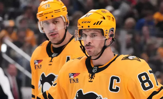 Pittsburgh Penguins' Sidney Crosby (87) and Evgeni Malkin (71) prepare for a face-off during the second period of an NHL hockey game against the Dallas Stars in Pittsburgh, Saturday, Oct. 10, 2026. (AP Photo/Gene J. Puskar)