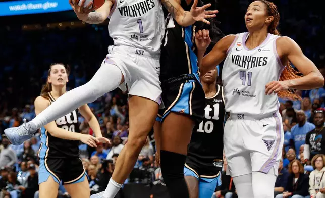 Golden State Valkyries forward Gabby Williams (1) shoots the ball while defended by Atlanta Dream forward Angel Reese (5)during the second half of Game 3 of the WNBA basketball finals on Wednesday, Oct. 21, 2026, in Atlanta. (Santiago Mejia/San Francisco Chronicle via AP)