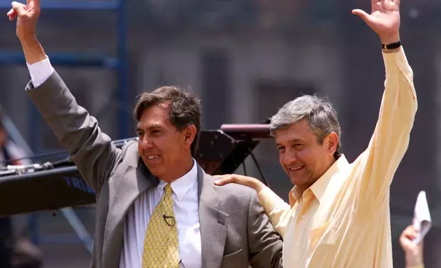 FILE - Mexican leftist opposition presidential candidate Cuauhtemoc Cardenas, right, greets supporters with leftist Mexico City mayoral candidate Andres Manuel Lopez Obrador during a campaign rally in Mexico City's Zocalo plaza, June 25, 2000. (AP Photo/John Moore, File)