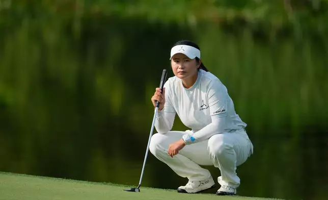 Yu Liu of China lines a putt on the 3rd hole during the third day of LPGA Maybank Championship in Kuala Lumpur, Malaysia, Saturday, Oct. 31, 2026. (AP Photo/Vincent Thian)