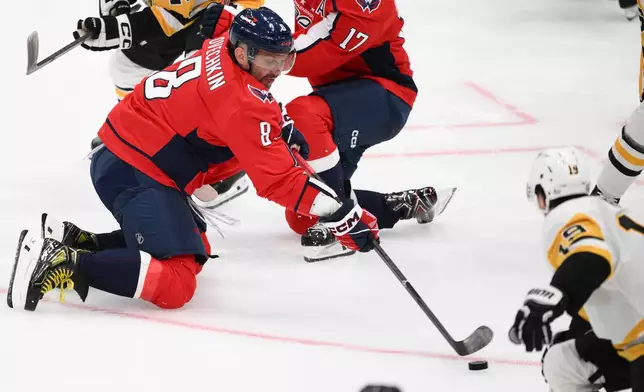 Washington Capitals left wing Alex Ovechkin (8) shoots the puck during the third period of an NHL hockey game against the Pittsburgh Penguins, Wednesday, Oct. 7, 2026, in Washington. (AP Photo/Nick Wass)