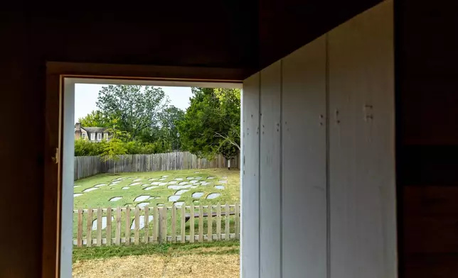 A burial ground sits just outside the reconstructed African Baptist Meeting House, now known as the First Baptist Church of Williamsburg, during a rededication ceremony in Williamsburg, Va., Friday, Oct. 9, 2026. (AP Photo/Mike Kropf)