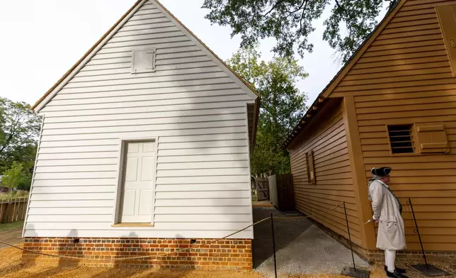 Shadows are cast on the facade of the reconstructed African Baptist Meeting House, now known as the First Baptist Church of Williamsburg, during a rededication ceremony in Williamsburg, Va., Friday, Oct. 9, 2026. (AP Photo/Mike Kropf)
