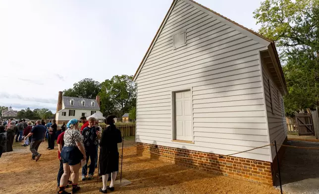 Residents gather for a community-wide rededication ceremony of the reconstructed African Baptist Meeting House, now known as the First Baptist Church of Williamsburg, in Williamsburg, Va., Friday, Oct. 9, 2026. (AP Photo/Mike Kropf)