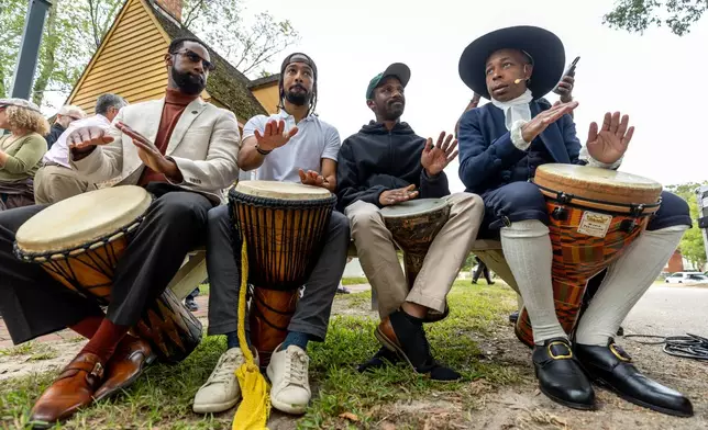 People drum during a community-wide rededication ceremony of the reconstructed African Baptist Meeting House, now known as First Baptist Church of Williamsburg, in Williamsburg, Va., Friday, Oct. 9, 2026. (AP Photo/Mike Kropf)