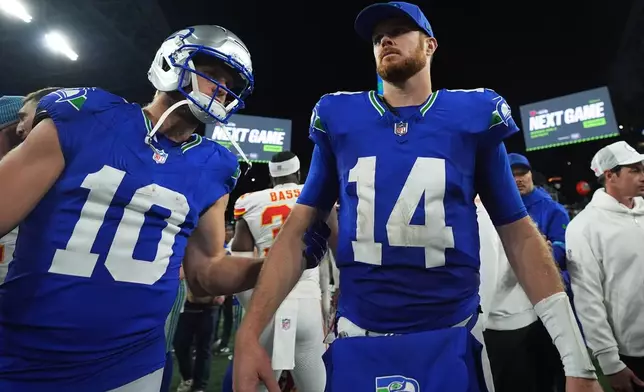 Seattle Seahawks quarterback Sam Darnold (14) and Seahawks wide receiver Cooper Kupp, left, leave the field after an NFL football game against the Kansas City Chiefs in Seattle, Sunday, Oct. 25, 2026. (AP Photo/Lindsey Wasson)
