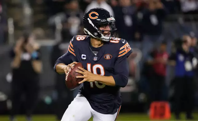 Chicago Bears quarterback Caleb Williams rolls out of the pocket during the first half of an NFL football game against the New England Patriots in Chicago, Thursday, Oct. 22, 2026. (AP Photo/Nam Y. Huh)