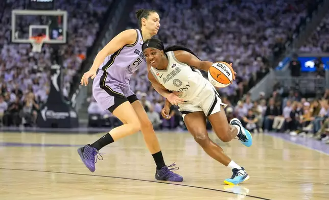 Las Vegas Aces guard Jackie Young (0) drives to the basket against Golden State Valkyries forward Cecilia Zandalasini (24) during the first half of Game 1 of the WNBA basketball semifinals in San Francisco, Sunday, Oct. 4, 2026. (AP Photo/Tony Avelar)