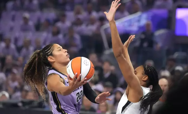 Golden State Valkyries guard Veronica Burton (22) drives to the basket against Las Vegas Aces' Brianna Turner, right, during the first half of Game 1 of the WNBA basketball semifinals in San Francisco, Sunday, Oct. 4, 2026. (AP Photo/Tony Avelar)