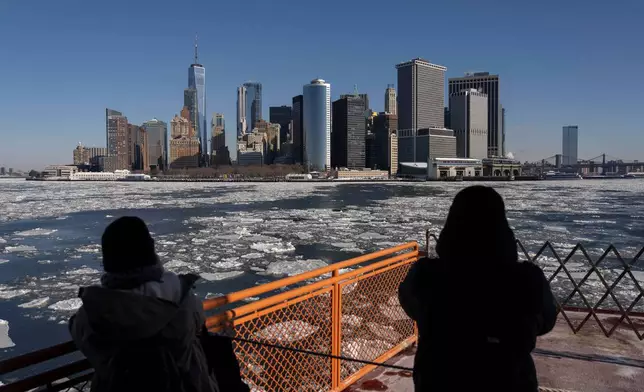 FILE - People take the Staten Island Ferry as ice floats on the Hudson River, Jan. 27, 2026, in New York. (AP Photo/Yuki Iwamura, File)