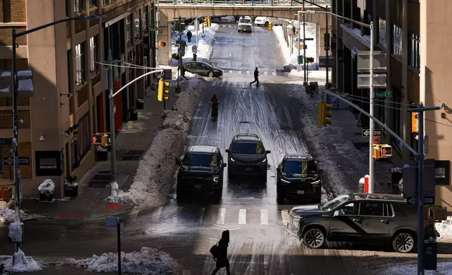 FILE - Pedestrians and cars pass through the Dumbo neighborhood of Brooklyn borough of New York, Feb. 24, 2026. (AP Photo/Yuki Iwamura, File)