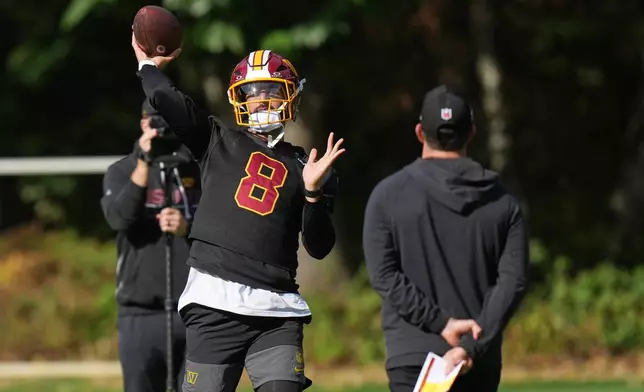 Washington Commanders' quarterback Marcus Mariota throws the ball during an NFL football practice in Hertfordshire, England, Friday, Oct. 2, 2026. (AP Photo/Alastair Grant)
