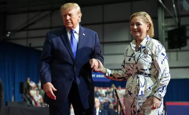 President Donald Trump, left, escorts Sen. Darline Graham, R-S.C., off the stage after Graham spoke during a campaign rally at Rock Hill Sports and Event Center, Thursday, Oct. 29, 2026, in Rock Hill, S.C. (AP Photo/Alex Brandon)