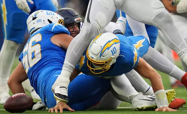 Los Angeles Chargers quarterback Justin Herbert (10) fumbles the ball during the second half of an NFL football game against the Denver Broncos, Sunday, Oct. 11, 2026, in Inglewood, Calif. (AP Photo/Gregory Bull)