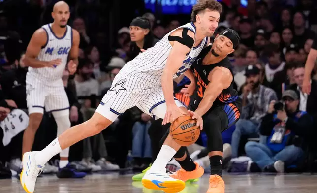 New York Knicks guard Josh Hart (3) blocks Orlando Magic forward Franz Wagner (22) during the first half of an NBA basketball game, Sunday, Oct. 25, 2026, in New York. (AP Photo/Yuki Iwamura)