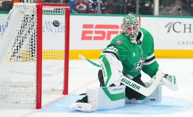 Dallas Stars goaltender Jake Oettinger watches a shot by the Colorado Avalanche go wide of his net during the second period of an NHL hockey game Tuesday, Oct. 13, 2026, in Dallas. (AP Photo/Julio Cortez)
