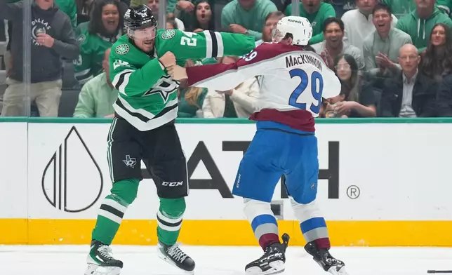 Dallas Stars center Roope Hintz (24) and Colorado Avalanche center Nathan MacKinnon (29) fight during the second period of an NHL hockey game Tuesday, Oct. 13, 2026, in Dallas. (AP Photo/Julio Cortez)