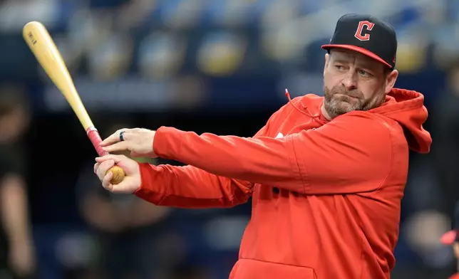 Cleveland Guardians manager Stephen Vogt hits to the infield during batting practice before Game 1 of an American League Championship Series baseball game between the Tampa Bay Rays and the Cleveland Guardians in St. Petersburg, Fla. Monday, Oct. 12, 2026. (AP Photo/Phelan M. Ebenhack)