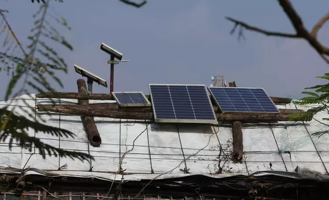 Solar panels sit on top of makeshift shelters to power homes and streetlights Oct. 3, 2026, in Teknaf, Bangaldesh. (AP Photo/Abdul Khan Dkl)