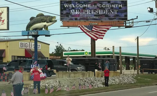 People watch as President Donald Trump's motorcade heads to a campaign rally in Corinth, Miss., Monday, Oct. 26, 2026. (AP Photo/Jacquelyn Martin)