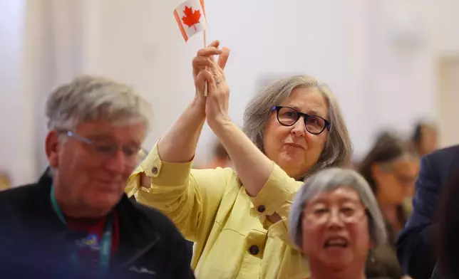 Supporters react to voting results at the pro Canada watch party in Edmonton, Alberta Monday, Oct. 19, 2026. (James Maclennan/The Canadian Press via AP)