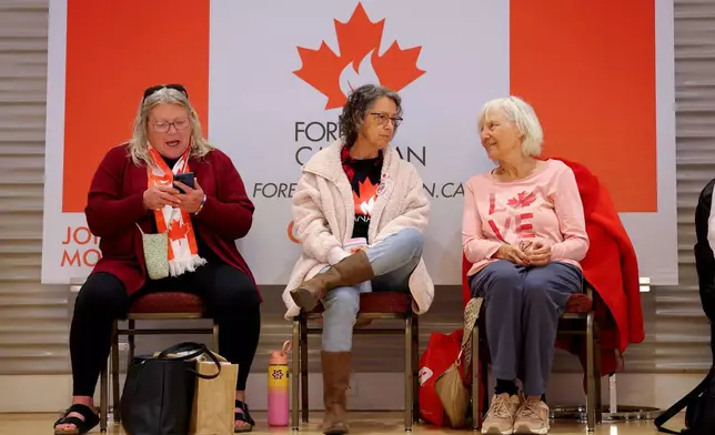 Supporters wait for results at the pro-Canada watch party in Edmonton, Alberta Monday, Oct. 19, 2026. (James Maclennan/The Canadian Press via AP)