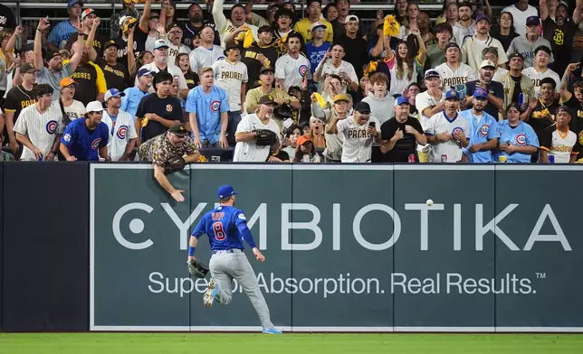 Chicago Cubs left fielder Ian Happ (8) chases down a double by San Diego Padres Jase Bowen in the fourth inning of Game 2 of the National League Wild Card baseball playoff series Wednesday, Sept. 30, 2026, in San Diego. (AP Photo/Gregory Bull)