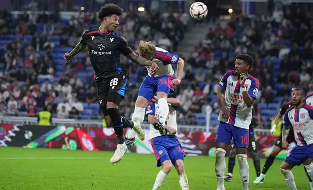 Crystal Palace's Chris Richards, left, battles for a header with Lyon's Pavel Sulc during the Europa League opening phase soccer match between Lyon and Crystal Palace in Lyon, France, Thursday, Oct. 15, 2026. (AP Photo/Laurent Cipriani)