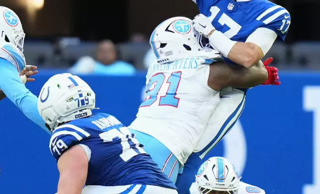 Indianapolis Colts quarterback Daniel Jones (17) throws a pass as he is pressured by Tennessee Titans defensive end John Franklin-Myers (91) during the second half of an NFL football game Sunday, Oct. 18, 2026, in Indianapolis. (AP Photo/AJ Mast)