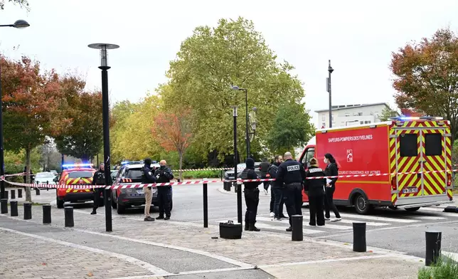 Police stand near a park after a shooting in Trappes, outside Paris, Friday, Oct. 23, 2026. (AP Photo/Emma Da Silva)