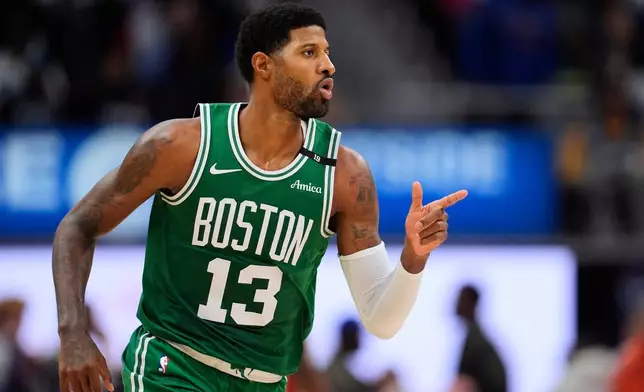 Boston Celtics forward Paul George (13) points after hitting a shot against the Detroit Pistons in the second half of an NBA basketball game in Detroit, Tuesday, Oct. 20, 2026. (AP Photo/Paul Sancya)