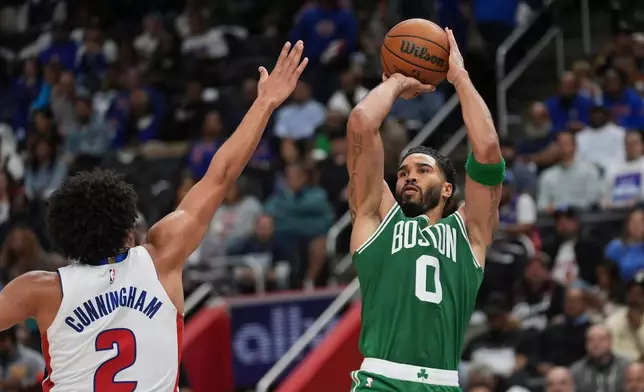 Boston Celtics forward Jayson Tatum (0) shoots on Detroit Pistons guard Cade Cunningham (2) in the first half of an NBA basketball game in Detroit, Tuesday, Oct. 20, 2026. (AP Photo/Paul Sancya)
