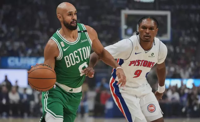 Boston Celtics guard Derrick White (9) drives on Detroit Pistons forward Ausar Thompson (9) in the first half of an NBA basketball game in Detroit, Tuesday, Oct. 20, 2026. (AP Photo/Paul Sancya)