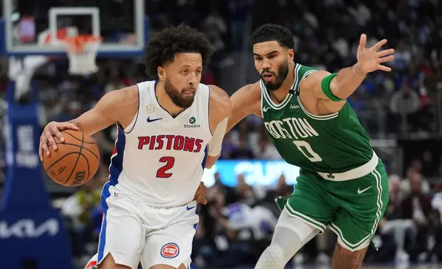 Detroit Pistons guard Cade Cunningham (2) drives on Boston Celtics forward Jayson Tatum (0) in the second half of an NBA basketball game in Detroit, Tuesday, Oct. 20, 2026. (AP Photo/Paul Sancya)